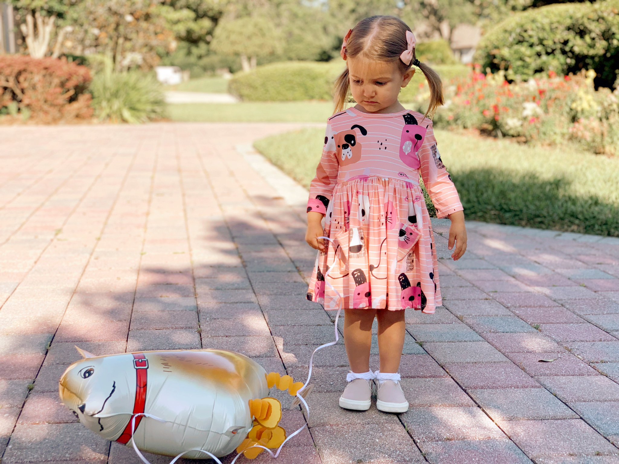 Pepper's 2nd Birthday "Puppy Paw-ty!" Creative party ideas via thinkingcloset.com - Doggy days pocket twirl dress with walking dog balloon for the cutest driveway photo shoot pre-party!