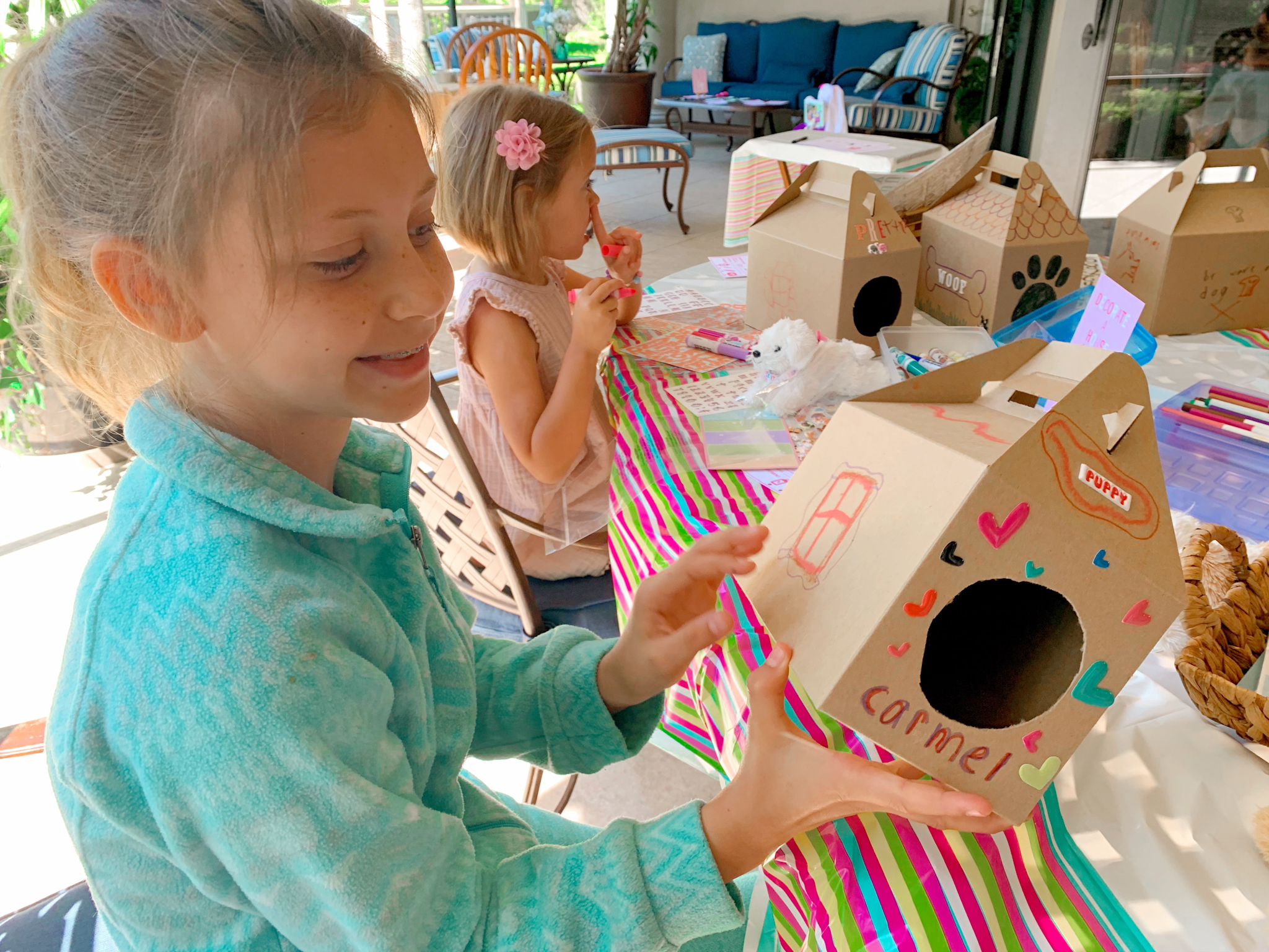 Pepper's 2nd Birthday "Puppy Paw-ty!" Creative party ideas via thinkingcloset.com - How to host a puppy-themed pawty with an adopt a puppy activity fun for all ages! The fourth station was where they decorated their dog house carriers!