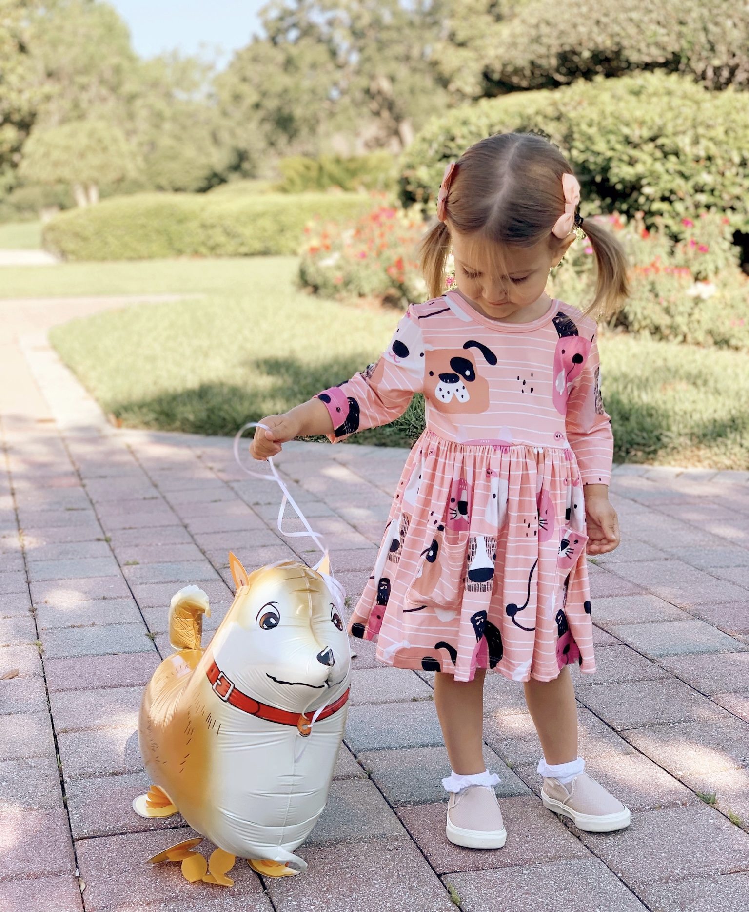 Pepper's 2nd Birthday "Puppy Paw-ty!" Creative party ideas via thinkingcloset.com - Doggy days pocket twirl dress with walking dog balloon for the cutest driveway photo shoot pre-party!