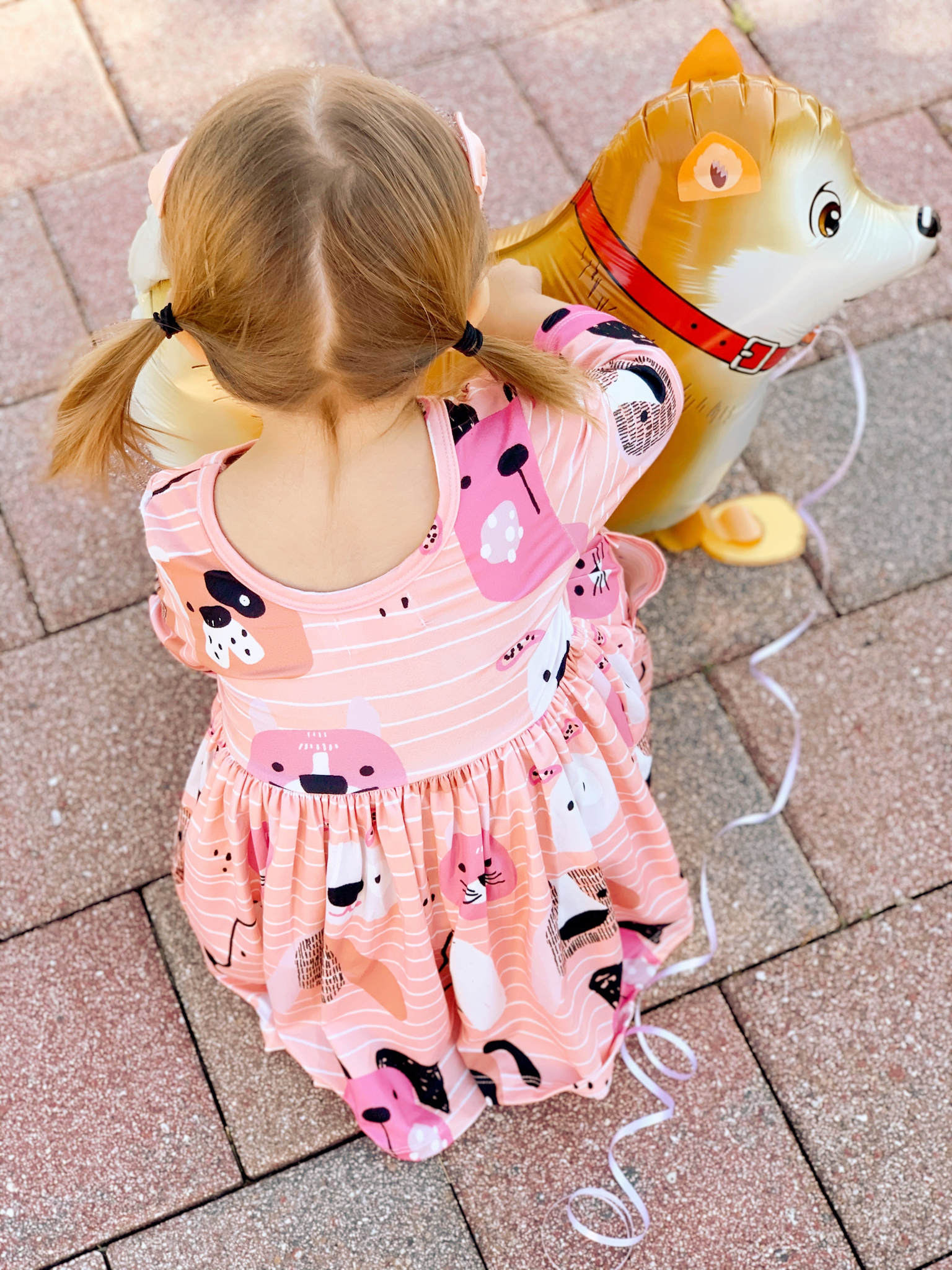 Pepper's 2nd Birthday "Puppy Paw-ty!" Creative party ideas via thinkingcloset.com - Doggy days pocket twirl dress with walking dog balloon for the cutest driveway photo shoot pre-party!
