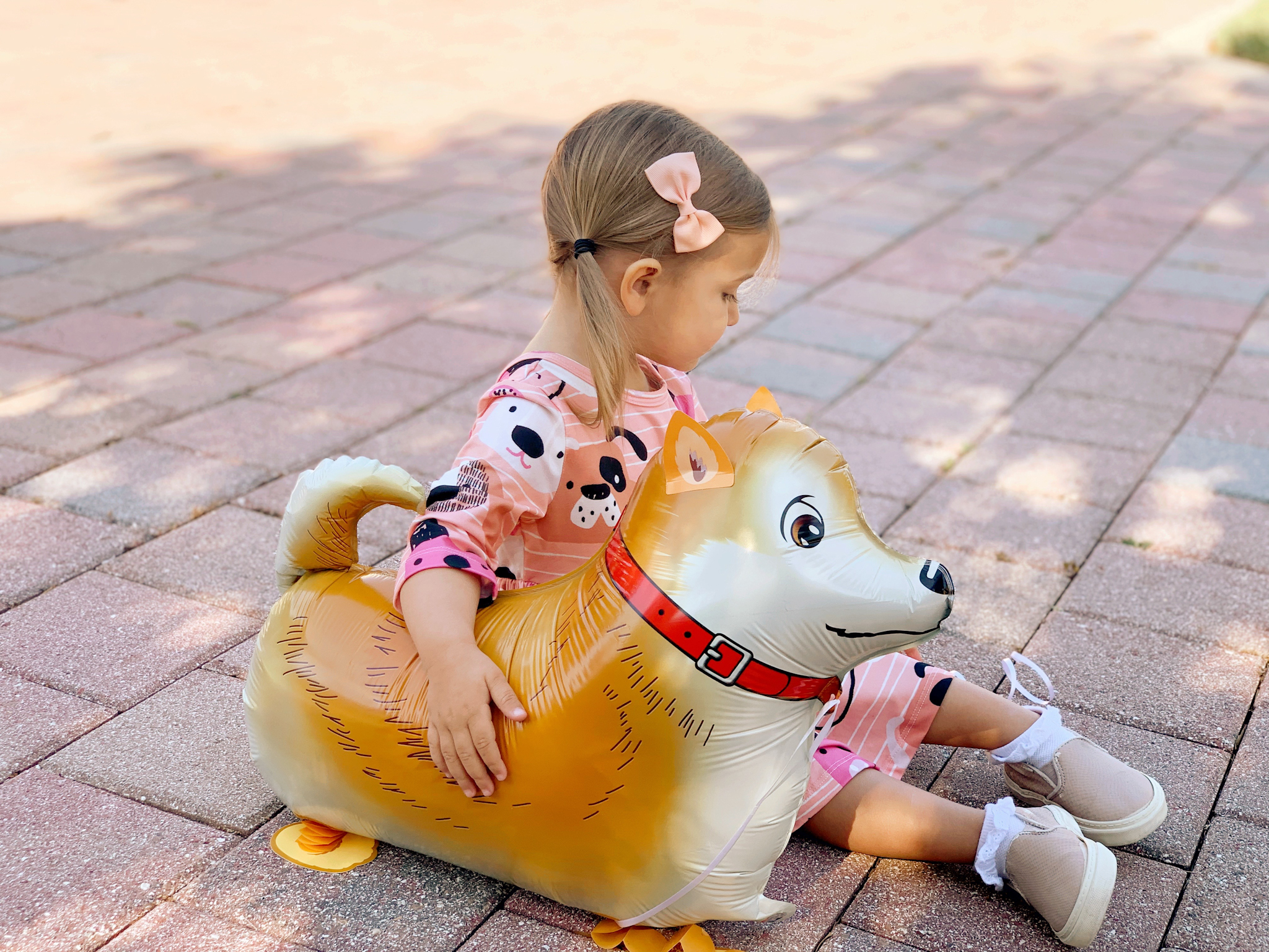 Pepper's 2nd Birthday "Puppy Paw-ty!" Creative party ideas via thinkingcloset.com - Doggy days pocket twirl dress with walking dog balloon for the cutest driveway photo shoot pre-party!