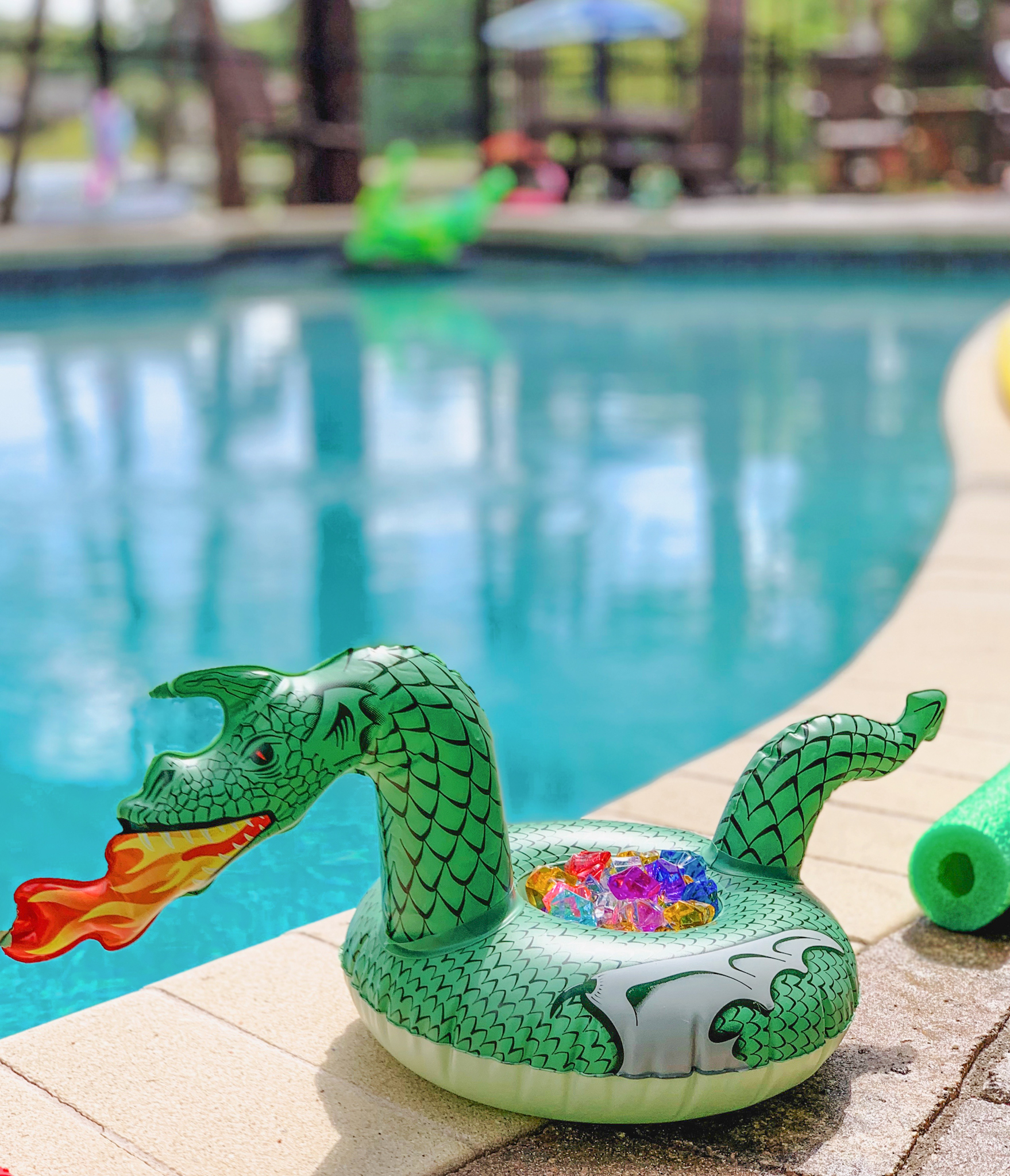 Pool noodle swords ready to slay the dragons in the moat and rescue the royal treasure! | Juniper's "Princesses & Knights" 5th Birthday Pool Party & Royal Golden Birthday Celebration | Creative ideas including a punny invitation, DIY castle backdrop, a golden birthday banner, creative activities for kids of all ages & party favors galore! via thinkingcloset.com