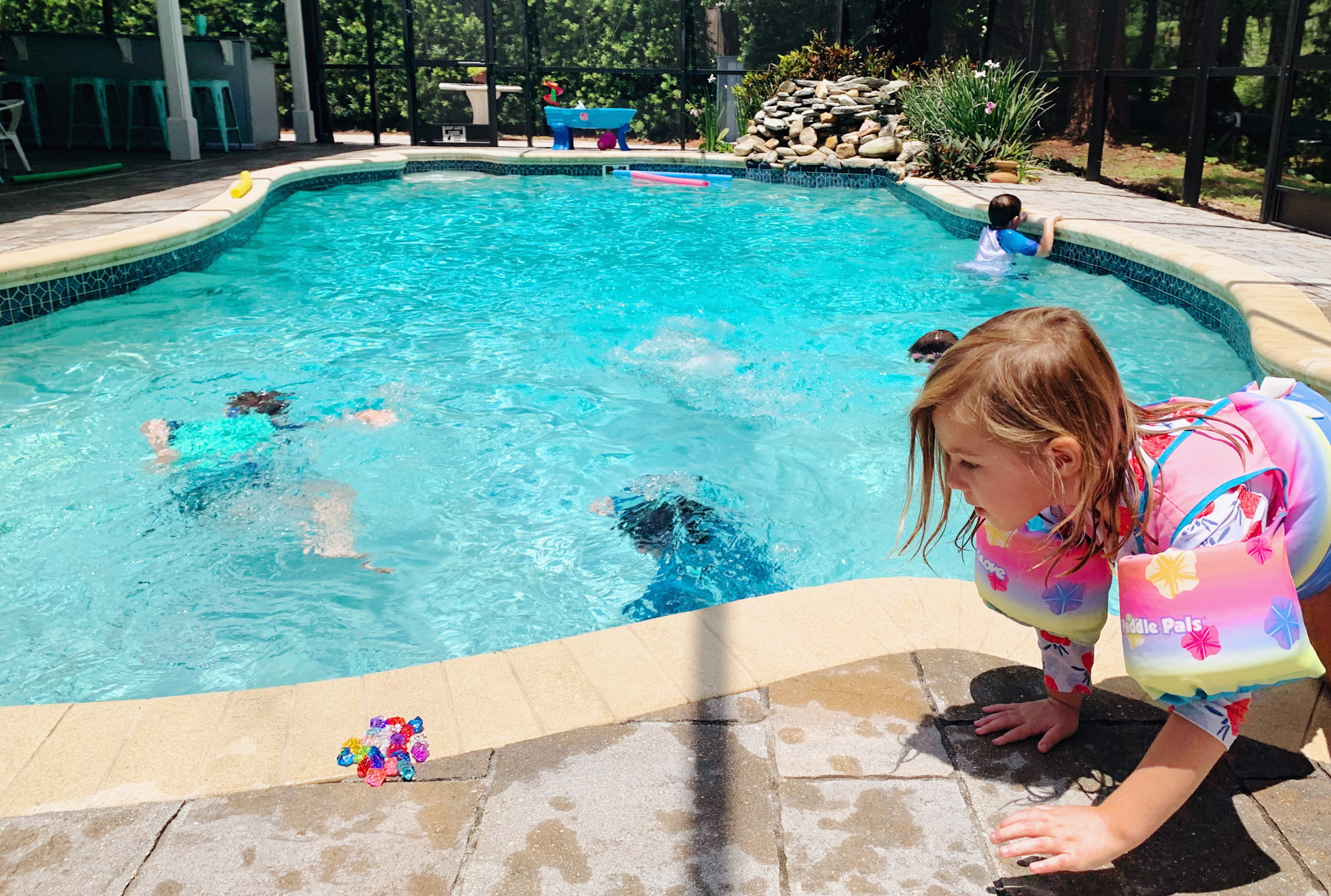 Pool Adventures at Juniper's "Princesses & Knights" 5th Birthday Pool Party & Royal Golden Birthday Celebration | Creative ideas including a punny invitation, DIY castle backdrop, a golden birthday banner, creative activities for kids of all ages & party favors galore! via thinkingcloset.com
