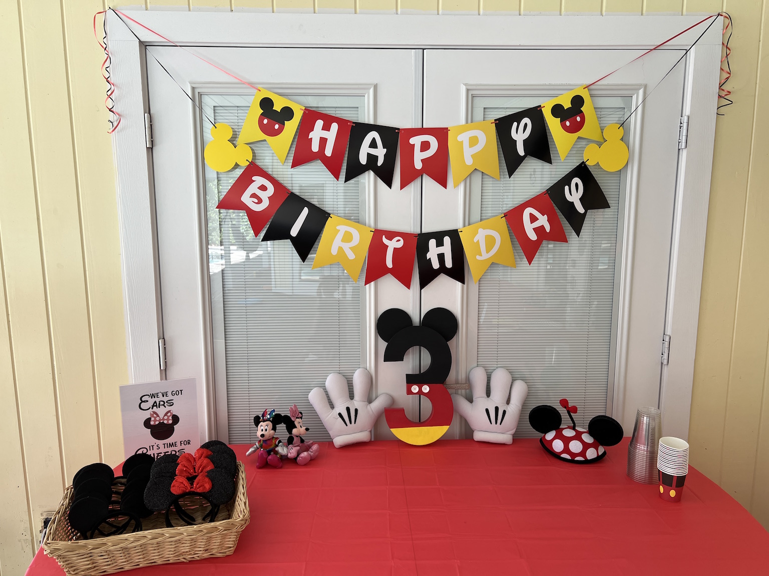 Party banners & do-able decor at Pepper's Magical "Mickey & Minnie Mouse" 3rd Birthday Pool Party | Creative ideas for hosting a magical Mickey & Minnie themed birthday bash for your little Mouseketeer with do-able decor, punny snacks, and party games that are fun for all ages! via thinkingcloset.com