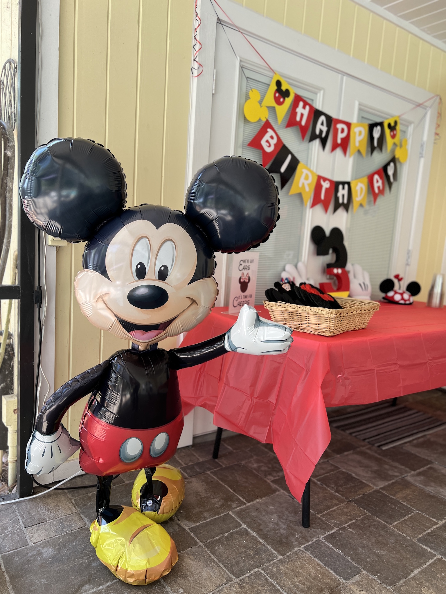 Life-size walking Mickey Mouse balloon decor at Pepper's Magical "Mickey & Minnie Mouse" 3rd Birthday Pool Party | Creative ideas for hosting a magical Mickey & Minnie themed birthday bash for your little Mouseketeer with do-able decor, punny snacks, and party games that are fun for all ages! via thinkingcloset.com