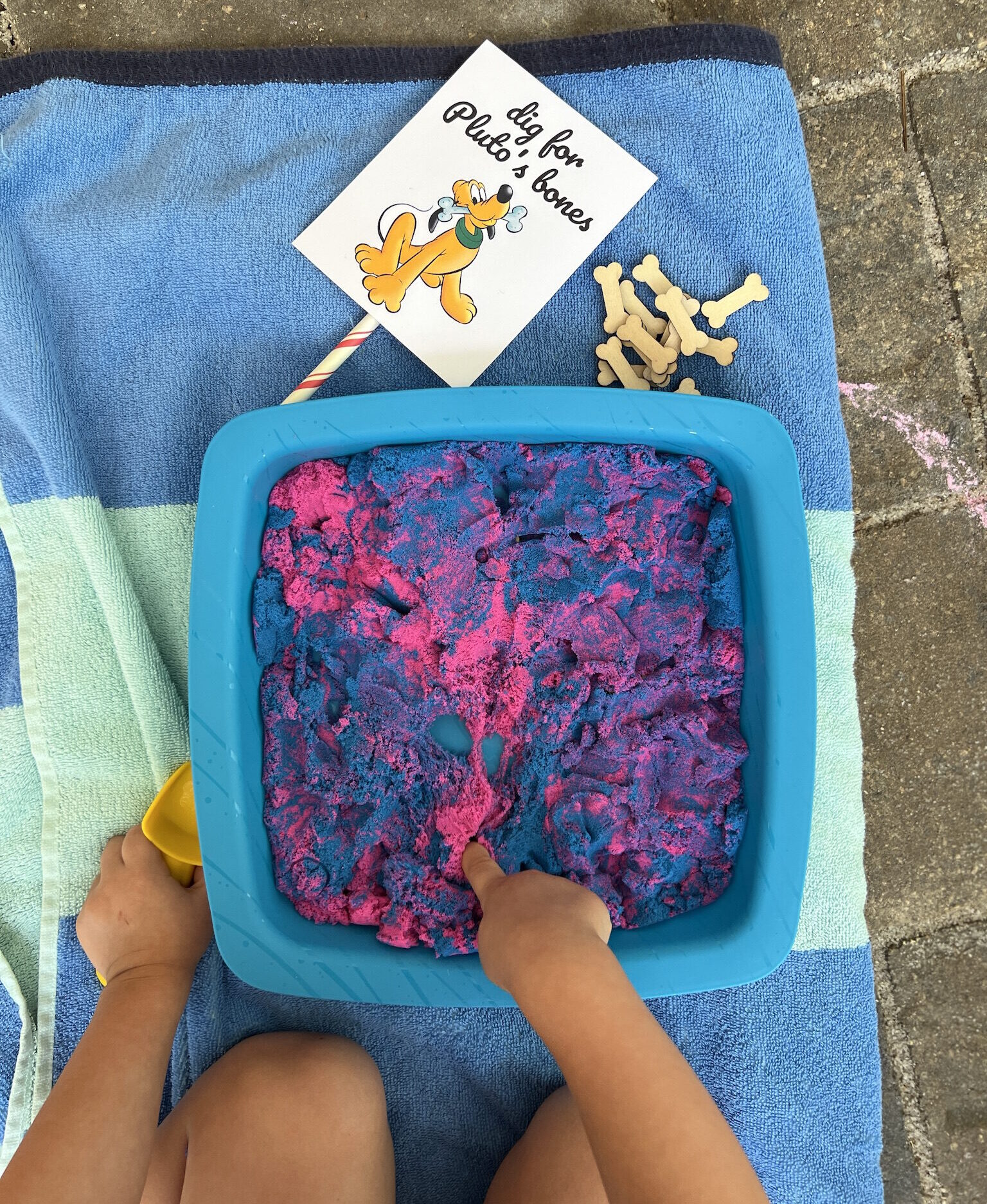 Dig for Pluto's Bones Sensory Bin Activity at Pepper's Magical "Mickey & Minnie Mouse" 3rd Birthday Pool Party | Creative ideas for hosting a magical Mickey & Minnie themed birthday bash for your little Mouseketeer with do-able decor, punny snacks, and party games that are fun for all ages! via thinkingcloset.com