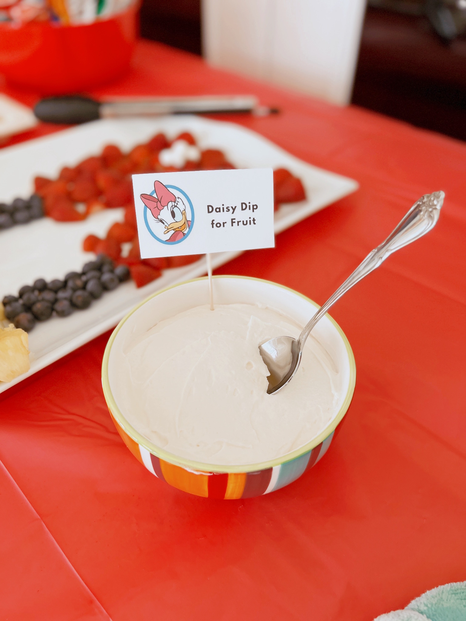 Mickey Mouse fruit platter and Daisy Dip at Pepper's Magical "Mickey & Minnie Mouse" 3rd Birthday Pool Party | Creative ideas for hosting a magical Mickey & Minnie themed birthday bash for your little Mouseketeer with do-able decor, punny snacks, and party games that are fun for all ages! via thinkingcloset.com