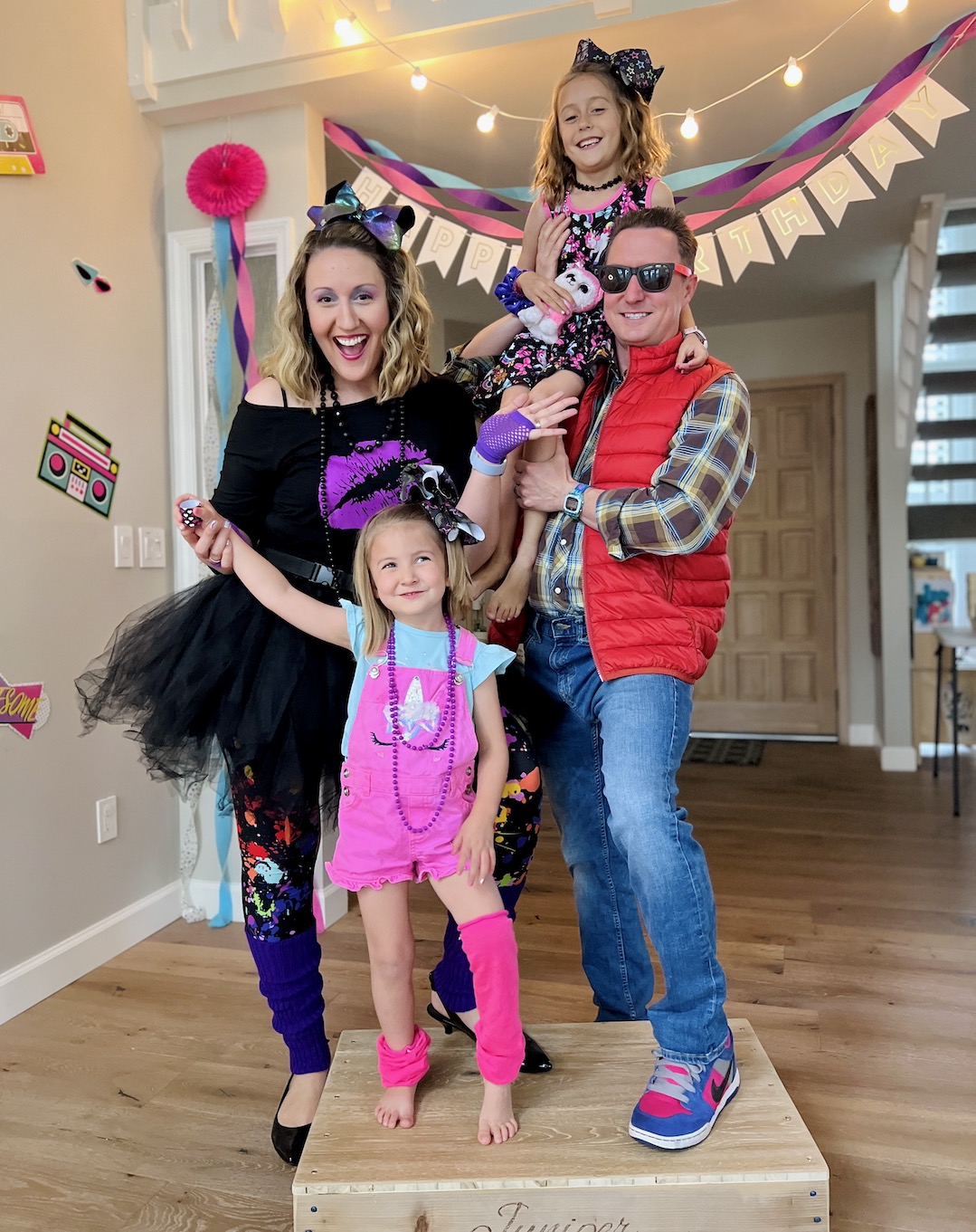 The whole fantastic fam at Lauren's 1980s Themed 40th Birthday Karaoke Party | Turns out that turning 40 can be totally tubular! Hop over to ThinkingCloset.com for the 411 on this bodacious birthday bash to remember–from the Lisa Frank style cake to the blessing circle to the 1980s fashion to the rockin' karaoke!